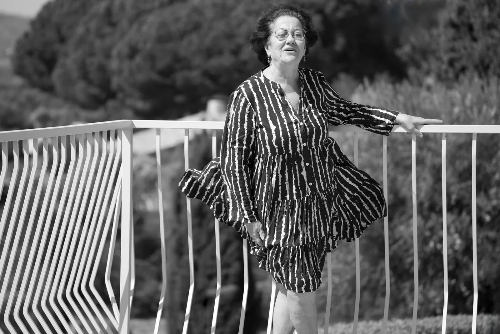 Stylish mature woman enjoying a breezy summer day in a dress