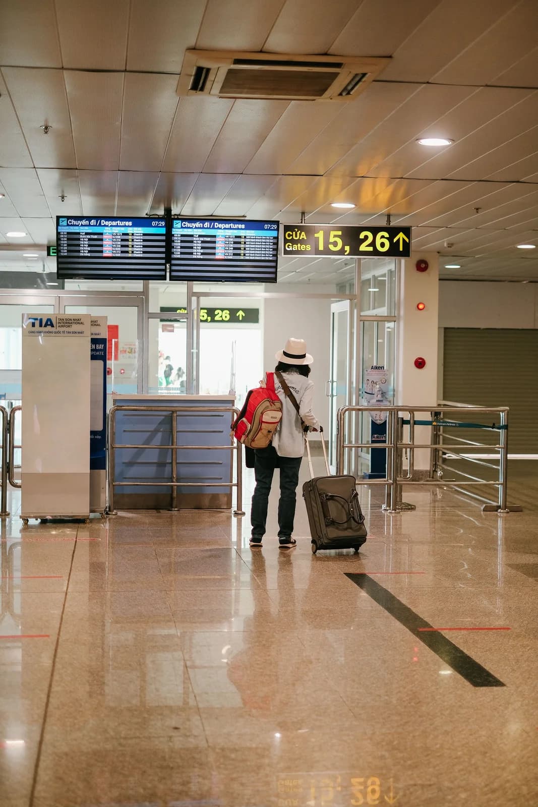 Traveler with luggage walking through an airport terminal